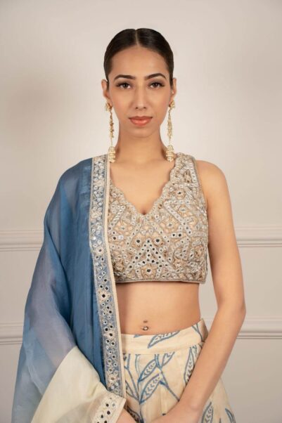 Vivid bridal ensemble with bold patterns, inspired by the chic and glamorous designs of Arpita Mehta.