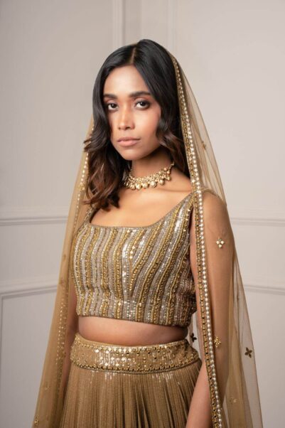 Graceful green lehenga with golden details for a regal wedding look - sawan gandhi's style